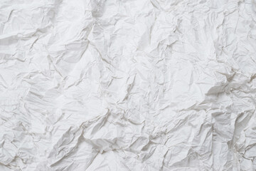 Crumpled white paper background.