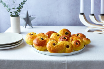 Plate of Swedish Saffron Bun with Plates on the Side, Horizontal