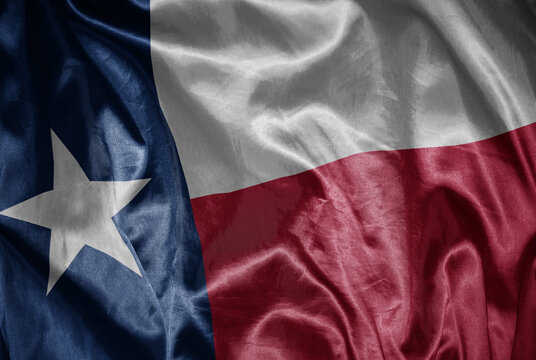 waving shining big flag of texas state on a silky texture