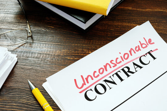 Contract with handwritten word unconscionable on the table.