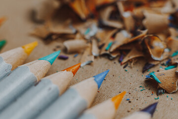 selective focus: artistic creative atmosphere: sharpened colored pencils on a craft paper background