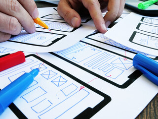 The Ux ui designer develops the design of a mobile application.