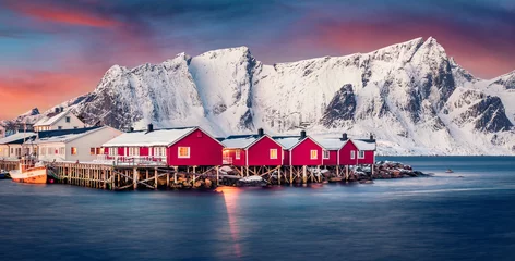 Poster Panoramic winter cityscape of small fishing town - Hamnoy, Norway, Europe. Picturesque morning seascape of Norwegian sea. Iconic landscape of Lofoten Island. Sunset over polar circle. © Andrew Mayovskyy