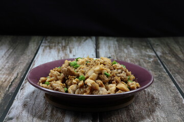 Traditional fried and stirred minced pork with cutting green bean and seasoning with soy sauce and pepper on the plate. Famous local street food in Thailand.