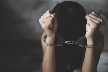 woman hands in handcuffs, human trafficking Concept, stop violence against women, Stop women abuse,...