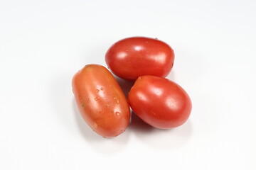Pile of fresh and organic Cherry tomato or Plum tomato isolated on the white background. Famous ingredients in Thai local cuisine. 