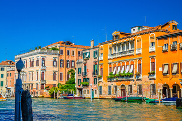 Grand Canal waterway with colorful multicolored palace buildings and moored boats in Cannaregio...