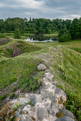 Castle ruins abandoned in the infinite beauty of the expansive green with river view. Rūjiena castle ruins.