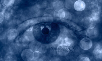 Beautiful girl's colorful eye with mystical bokeh effect 