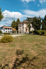 Fototapeta na wymiar Ancient villa surrounded by nature in the hills in Switzerland. Sunny summer day