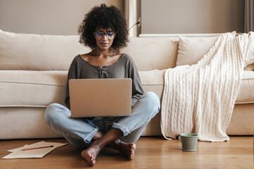 Young afro american woman using laptop