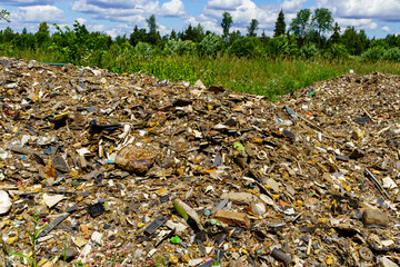 An illegal huge pile of crushed garbage in a field near Moscow as an example of a disrespectful attitude towards ecology