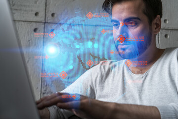 A serious caucasian manager in casual wears, using laptop to develop a new worldwide supply chain. Double exposure. globe and map hologram.