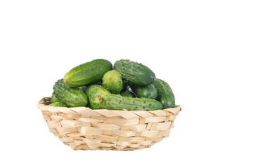 delicious cucumbers in a wicker bowl isolated on white background. Healthy food concept