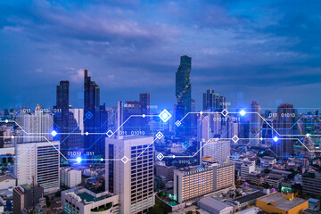 Fototapeta na wymiar Glowing hologram of technological process, aerial panoramic cityscape of Bangkok at sunset. The largest innovative hub of tech services in Asia. Multi exposure.