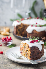 Fototapeta na wymiar Traditional Christmas cake with fruits, nuts and white glaze with Christmas decorations