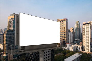 Obraz premium Blank white road billboard with Bangkok cityscape background at sunset. Street advertising poster, mock up, 3D rendering. Side view. The concept of marketing communication to promote or sell idea.