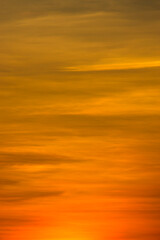 Vertical image The orange clouds on the sky in golden hour.