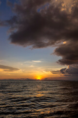 Sunset sky with cloud and silhouette mountain at the lake in golden time.