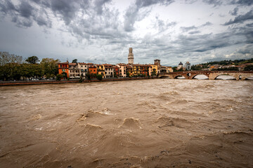 Fototapeta na wymiar Verona, Ponte Pietra (Stone bridge), I century B.C, and Adige river in flood after several violent storms. UNESCO world heritage site, Veneto, Italy, Europe