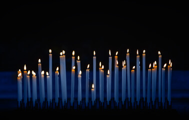 Set of burning candles in the church