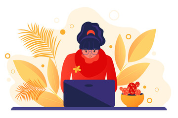 A young woman working at a computer. Online education. Freelance worker, self-employed, student. Autumn workplace interior design.