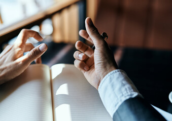 businesswoman in a cafe with a book on the table documents a cup of coffee work lifestyle