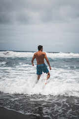 young man running on the beach