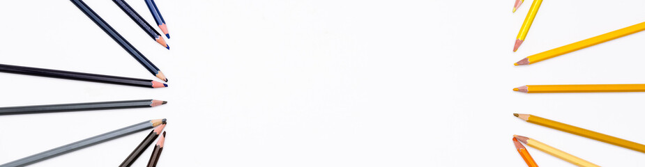 Frame of colored pencils isolated on white background by two side with free place for text. Banner with art stationery of the creative development and education of children and adults