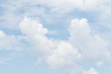 White fluffy clouds on a background of blue sky.