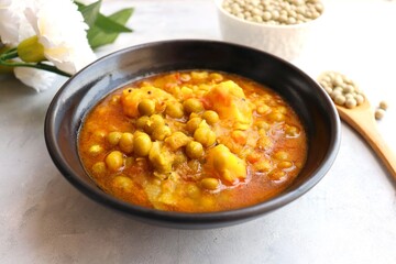 Indian popular homemade Aloo Matar. Potatoes and peas curry. Vatana batata bhaji or sabji. with cooking ingredients along with copy space. 