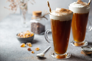 Iced coffee in a tall glasses with cream poured over