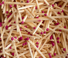 Many matches with bright pink heads, background.