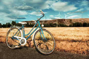 Fototapeta na wymiar vintage blue bicycle parked in the rural countryside in a summer day