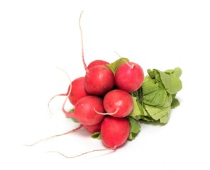 A bunch of red radishes with green tops isolated on a white background.