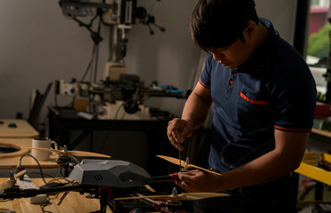 Engineer developing on drone in workshop.