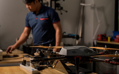 Engineer developing on drone in workshop.
