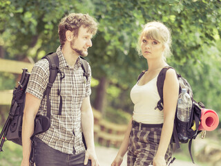 Hiking young couple with backpacks outdoor