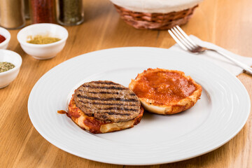 Delicious Turkish islak hamburger or wet burger on wooden table