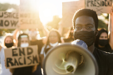 People from different culture and races protest on the street for equal rights - Demonstrators wearing face masks during black lives matter no racism campaign - Focus on black man eyes - obrazy, fototapety, plakaty