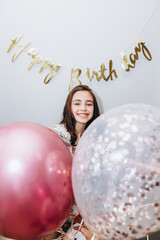 Fototapeta premium smiling girl on a wet background with the inscription Happy Birthday