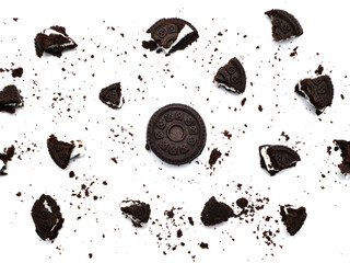 Sandwich chocolate cookies with a sweet cream with crumbs isolated on white background.