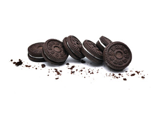 Sandwich chocolate cookies with a sweet cream with crumbs isolated on white background.