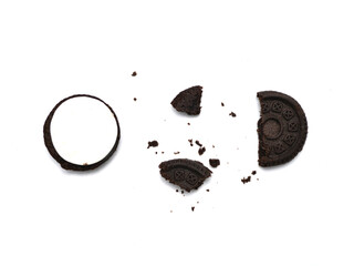 Sandwich chocolate cookies with a sweet cream with crumbs isolated on white background.