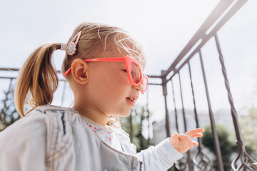 sincere children's laughter and fun, smiling girl playing and posing for a photo