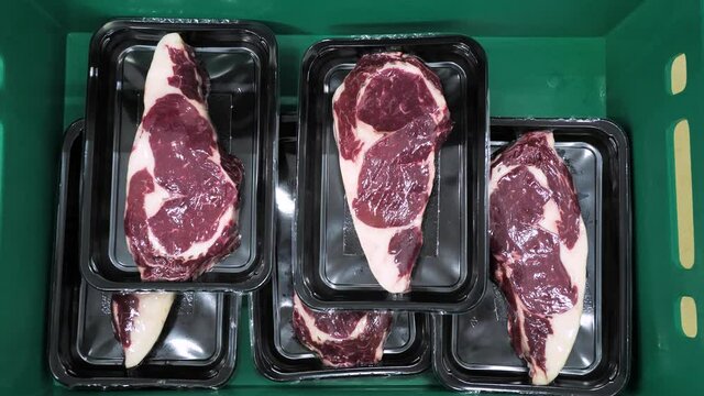 Packing of meat slices beef steaks in plastic container