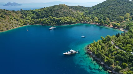 Zelfklevend Fotobehang Aerial drone photo of beautiful paradise beach of Skinos covered in pine trees in beautiful Ionian island of Ithaki or Ithaca, Greece © aerial-drone