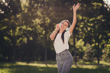 Portrait of her she nice attractive pretty lovely dreamy cheerful girl meloman enjoying spending free time pastime listening hit song single stereo sound fresh air dancing having fun