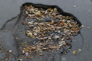 Road pits after the ground was washed away by rain.