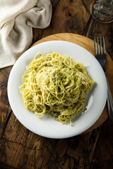 Spaghetti with pesto sauce and cheese